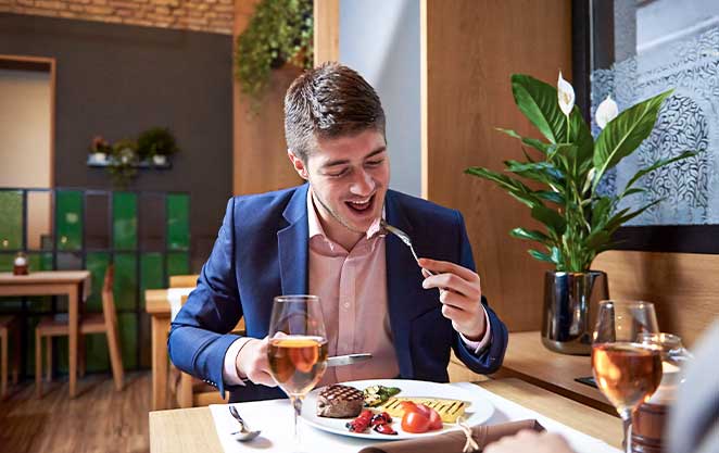 Handsome man's grin demonstrates the success of his tooth implant.