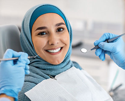 The positive dental experience at Glenn Smile Center is etched on a woman's elated face, reflecting the high-quality care expected from Aurora dentists like Dr. Gerald Glenn DDS.