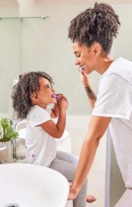 Proud mother and a daughter brushing their teeth. Glenn Smile Center Dentists