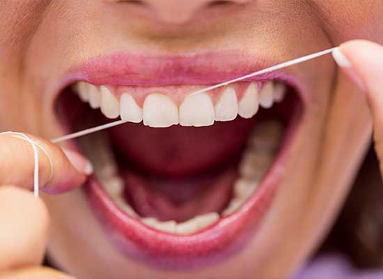 A woman display joyful smiles after thorough gum disease check-ups at Glenn Smile Center.