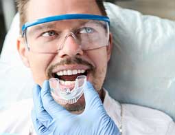 Handsome man approvingly nods to Glenn Smile Center's quality dental services.