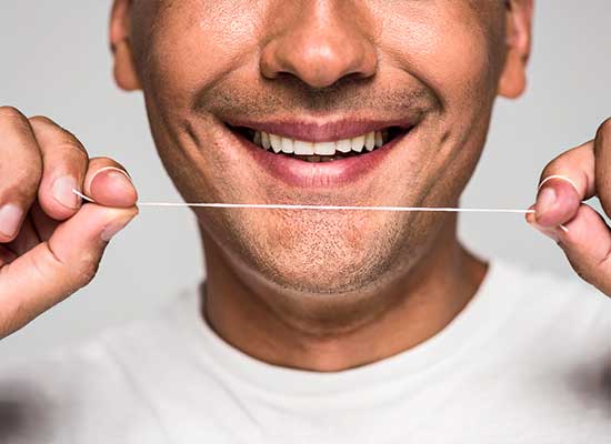 Man shows off a cavity-free smile, a sign of excellent pediatric dental care at Glenn Smile Center.