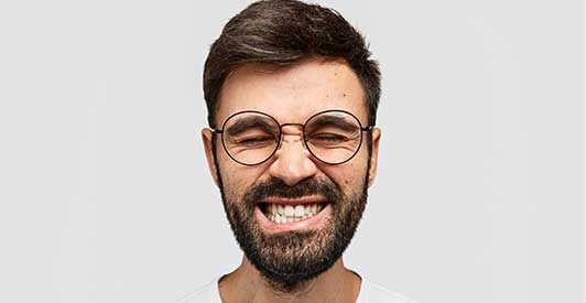 A man  perfect teeth are a testament to Glenn Smile Center's cosmetic dentistry mastery.