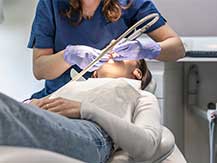 A woman receiving dental sedation during her teeth cleaning at Glenn Smile Center.