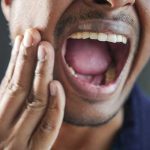 A Man grin tells the story of his victory over gum disease.